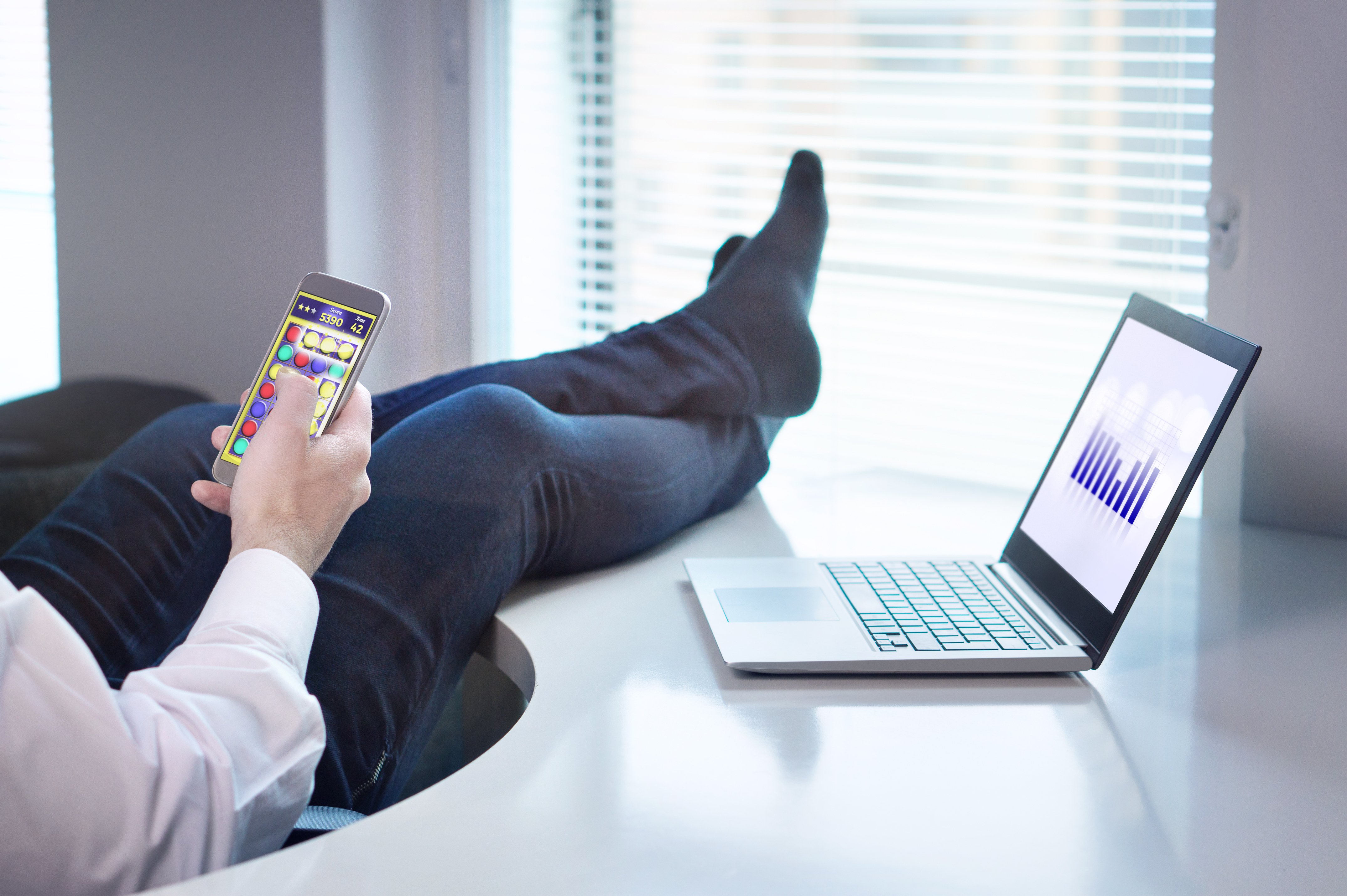 Man disengaging from work playing games