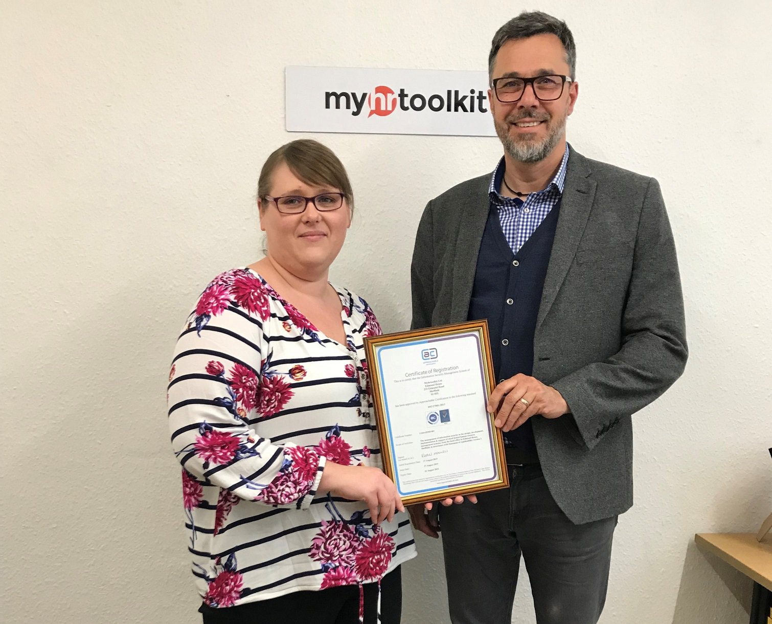 Amanda Grimstone and Jon Curtis with ISO 27001 certificate